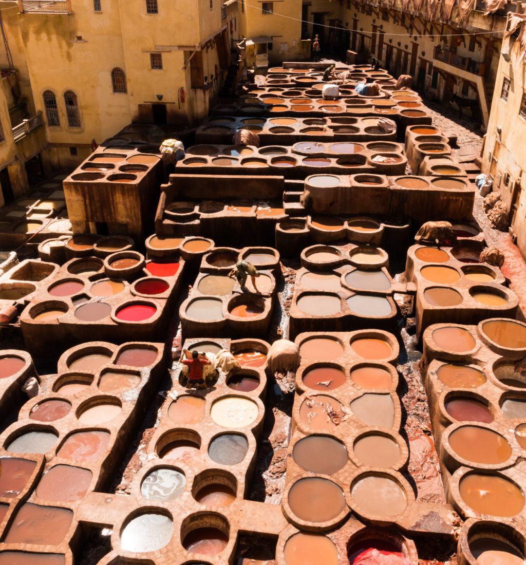 Fez, Morocco - March 9, 2018: View of stone vessels with dyes and leathers in a traditional tannery in the city of Fez, Morocco. Tourist attraction